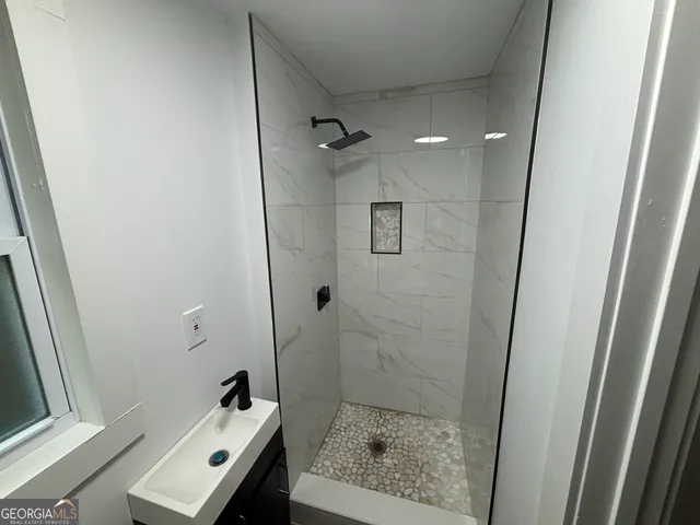 a bathroom with a sink toilet and shower