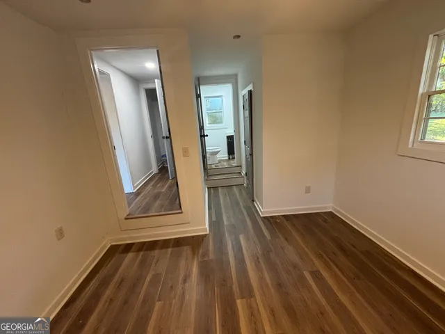 a view of a room with wooden floor and staircase