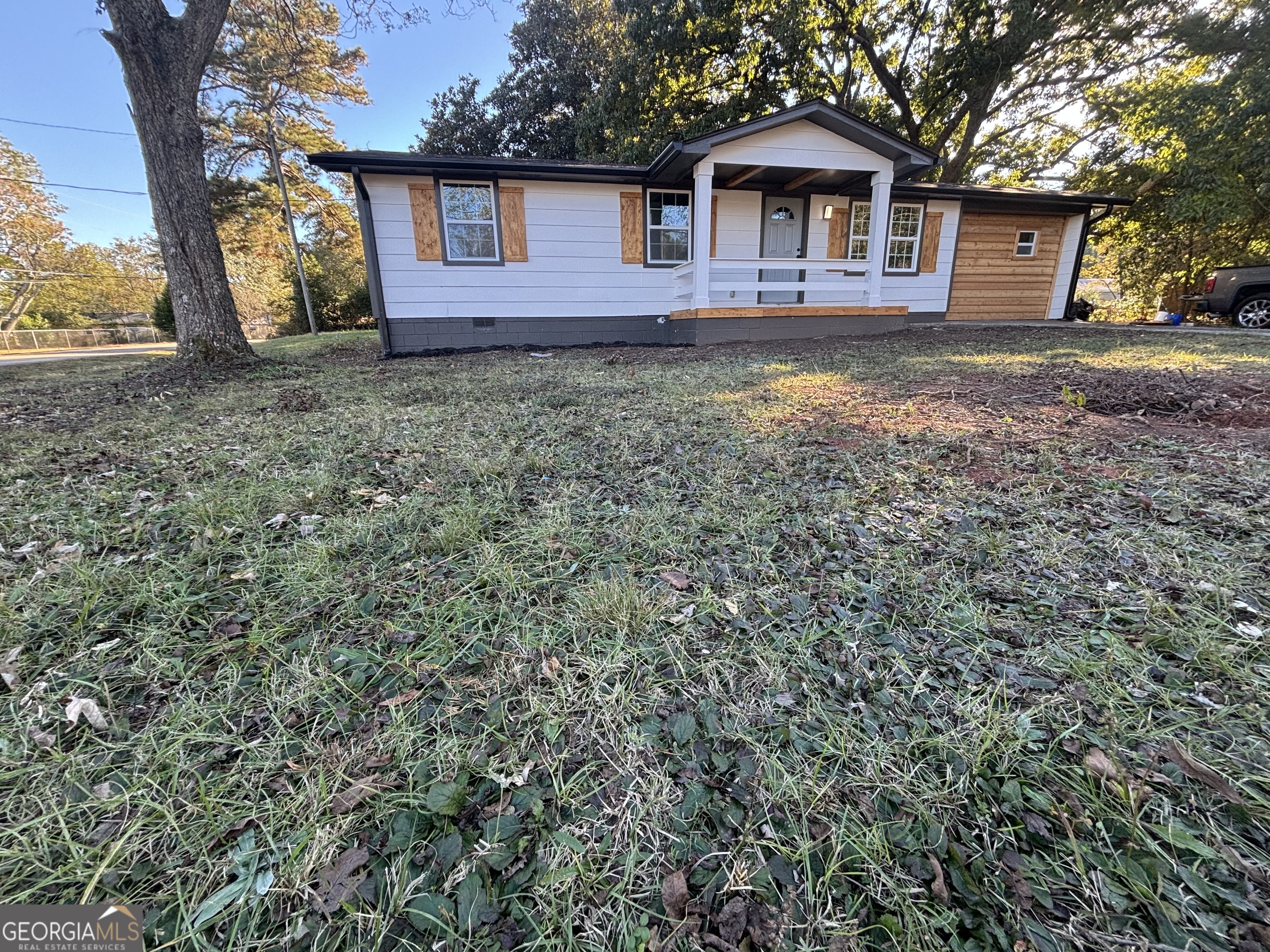 176 Randall Avenue Flovilla, GA 30216 - Photo 3 of 32 a view of a yard in front of a house with large trees
