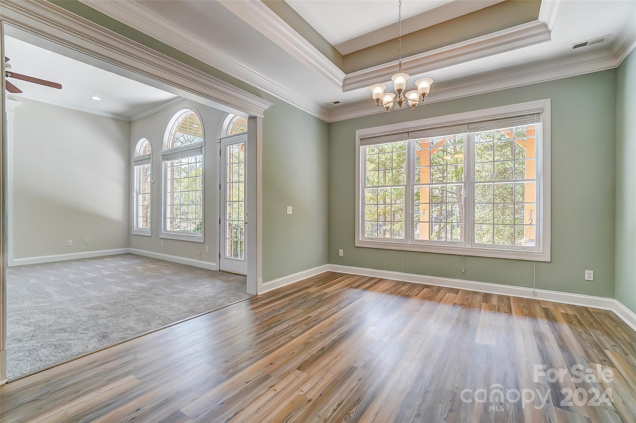 922 Cove Point Lane Tega Cay, SC 29708 - Photo 36 of 48 a view of an empty room with wooden floor and a window