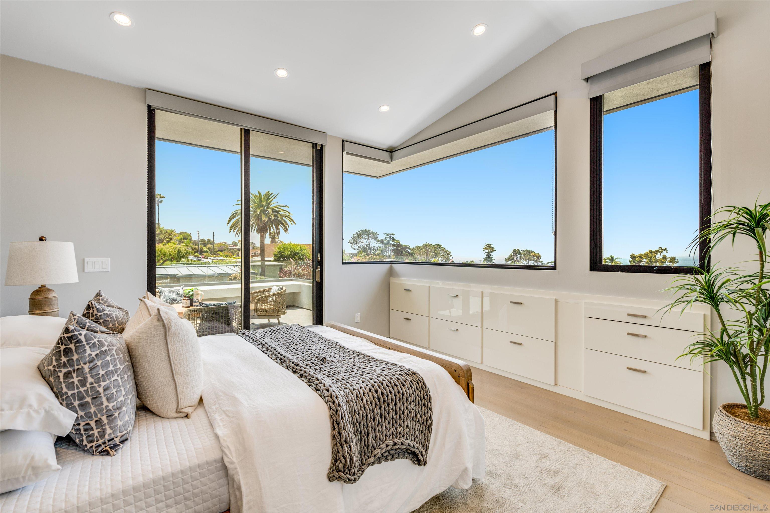 320 11th Street Del Mar, CA 92014 - Photo 21 of 45 a bedroom with a large bed and a potted plant
