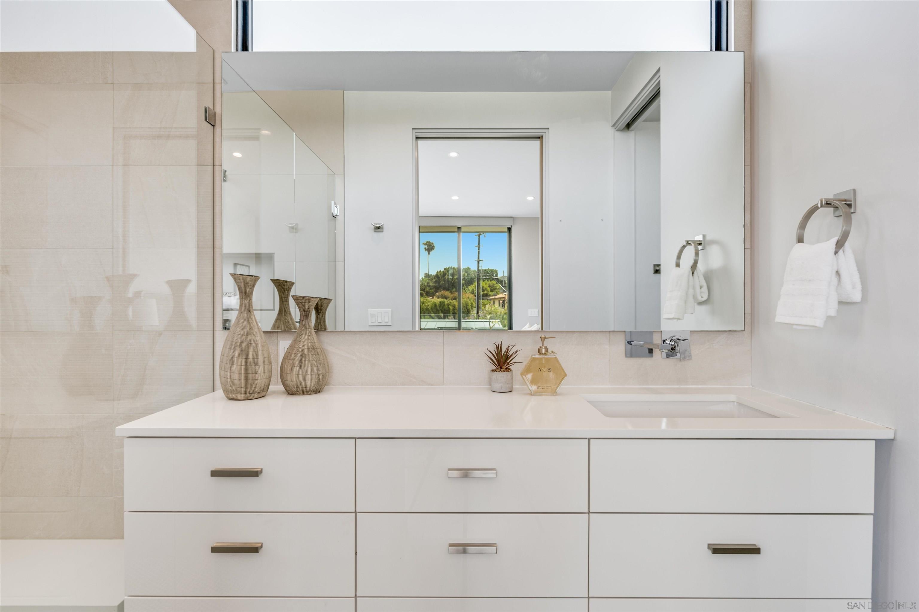 320 11th Street Del Mar, CA 92014 - Photo 23 of 45 a bathroom with double vanity sink and mirror