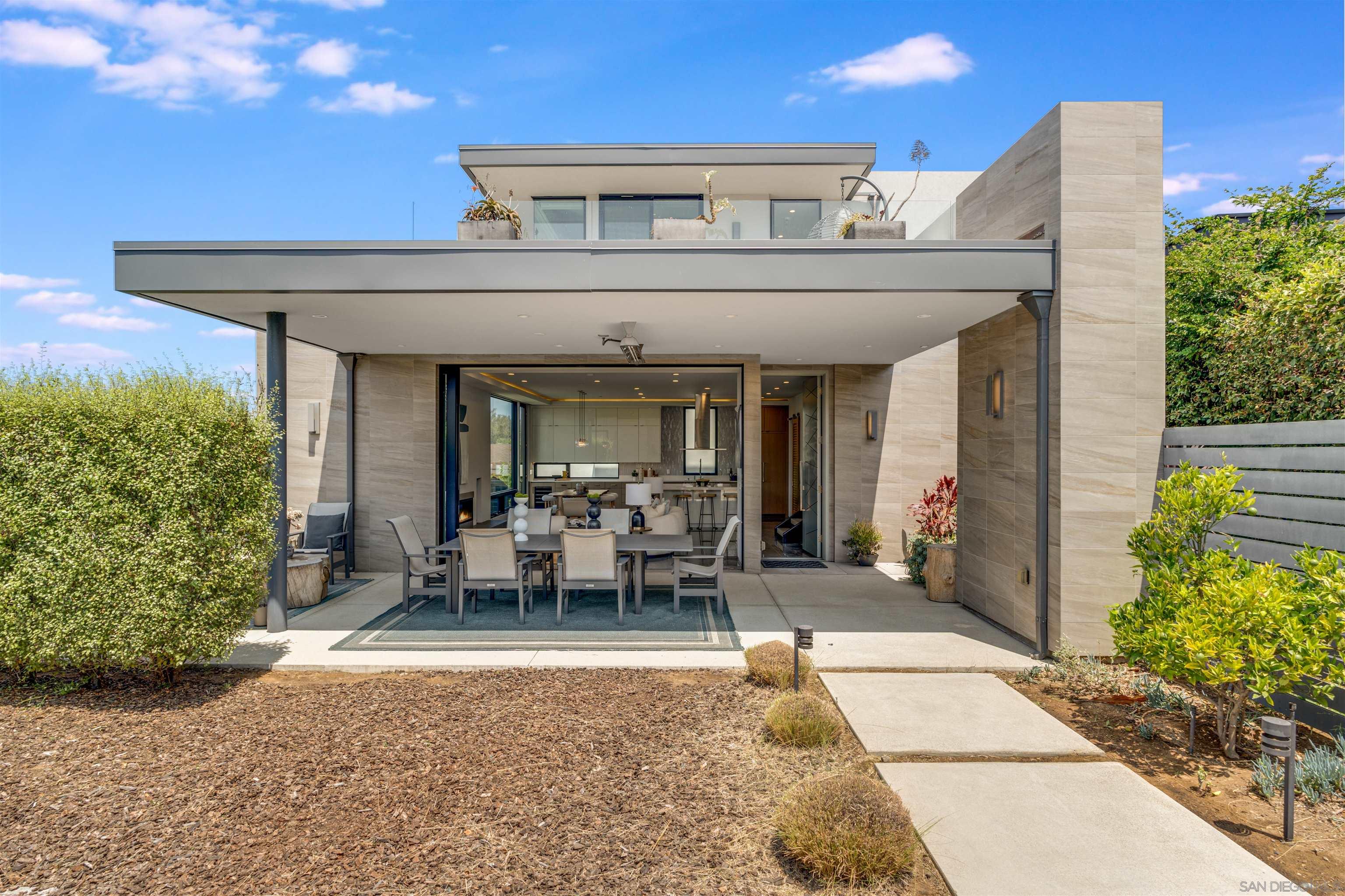 320 11th Street Del Mar, CA 92014 - Photo 28 of 45 a view of a patio with table and chairs potted plants and floor to ceiling window