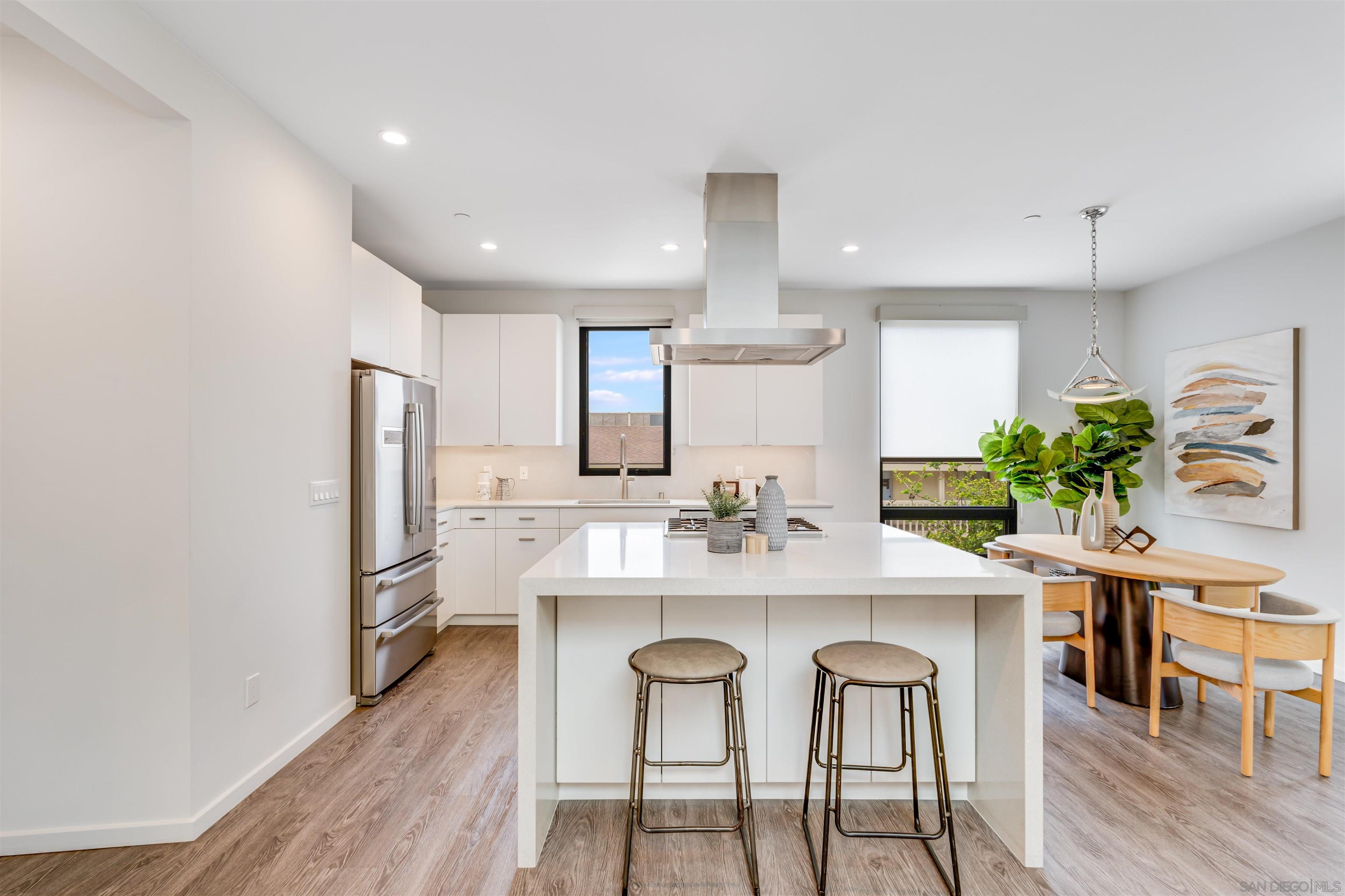 320 11th Street Del Mar, CA 92014 - Photo 34 of 45 a kitchen with kitchen island cabinets stainless steel appliances a sink and chairs