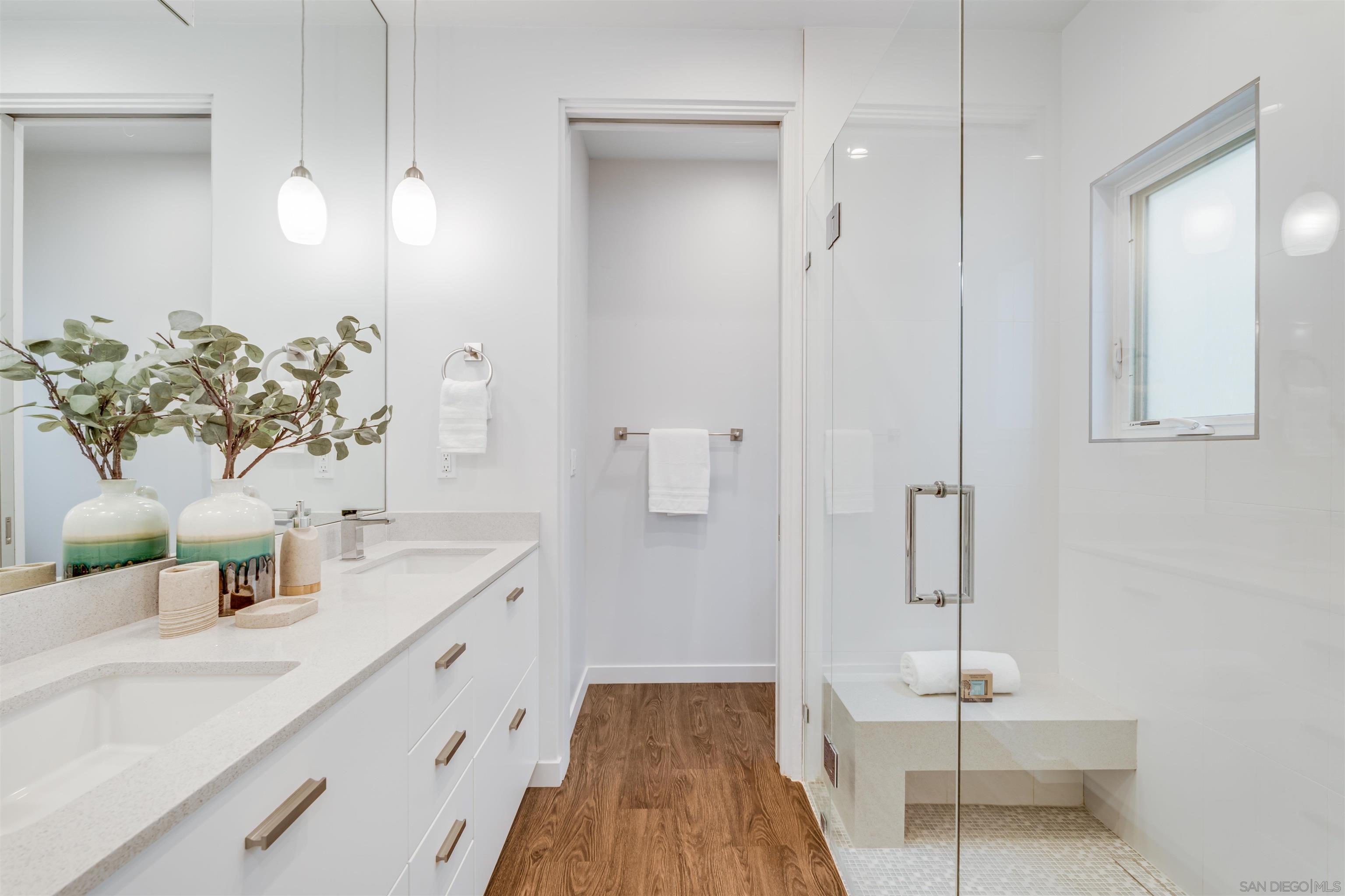 320 11th Street Del Mar, CA 92014 - Photo 40 of 45 a bathroom with a double vanity sink a mirror and a shower