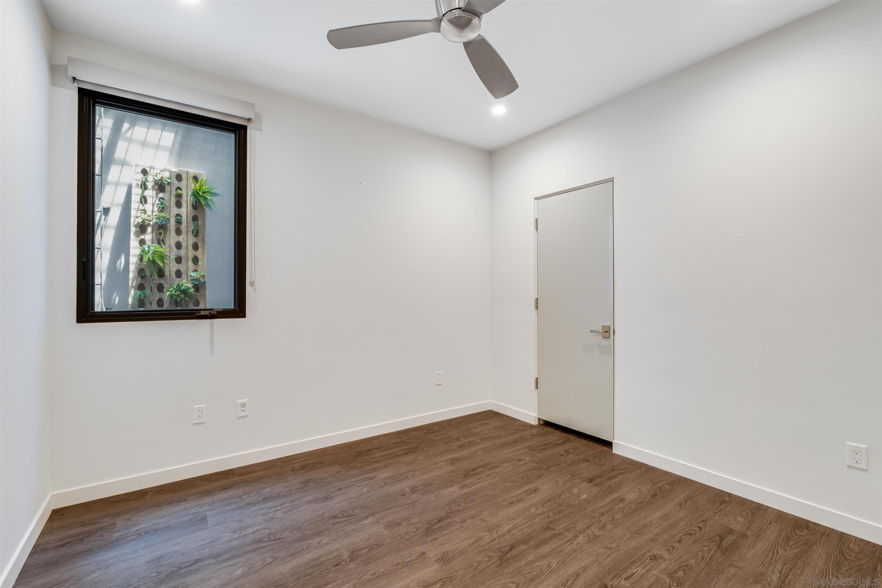 320 11th Street Del Mar, CA 92014 - Photo 41 of 45 an empty room with a ceiling fan and wooden floor