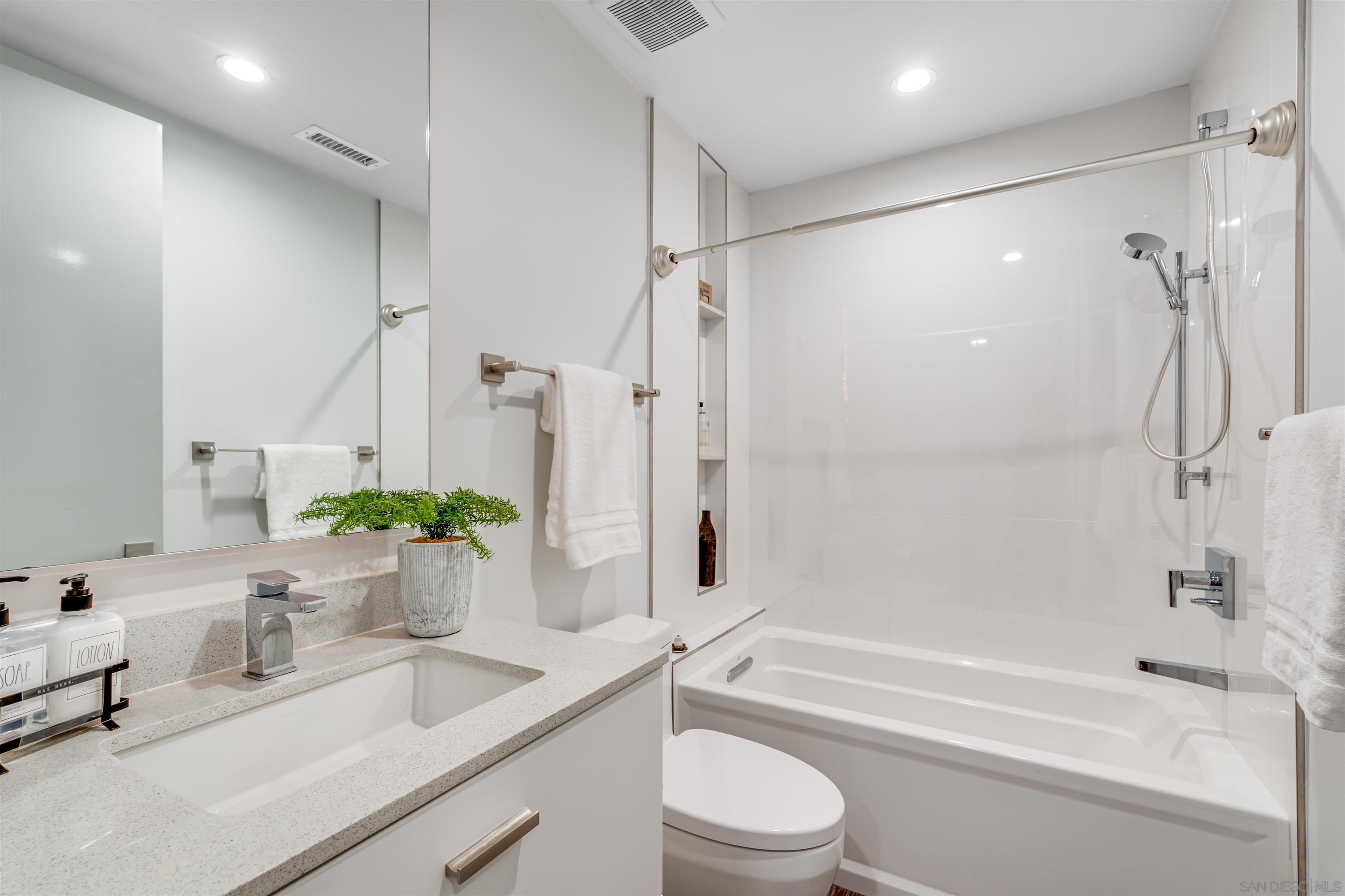 320 11th Street Del Mar, CA 92014 - Photo 43 of 45 a bathroom with a granite countertop sink a toilet and shower