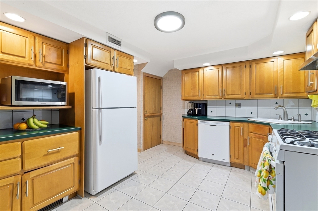 19 Clark Street Randolph, MA 02368 - Photo 12 of 30 a kitchen with a refrigerator and a stove top oven