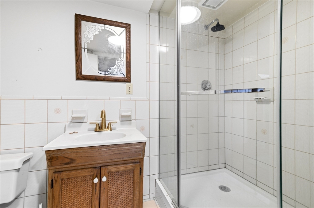 19 Clark Street Randolph, MA 02368 - Photo 18 of 30 a bathroom with a shower a sink and mirror