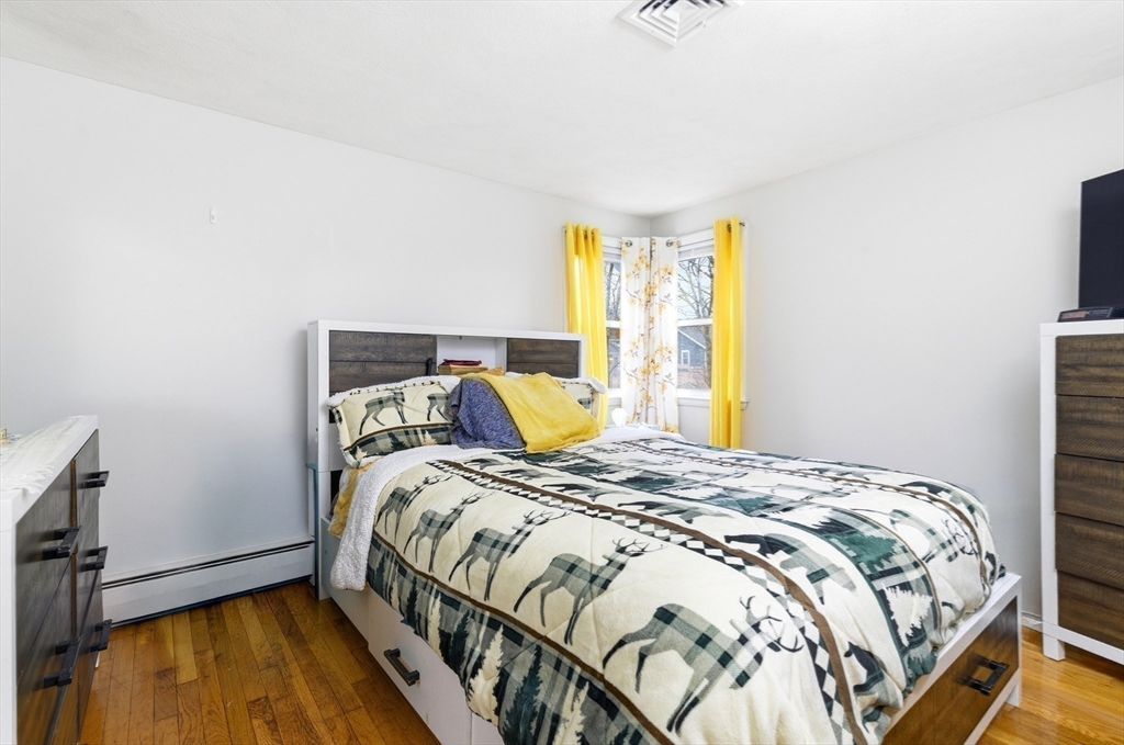 19 Clark Street Randolph, MA 02368 - Photo 21 of 30 a bed sitting in a bedroom next to a window