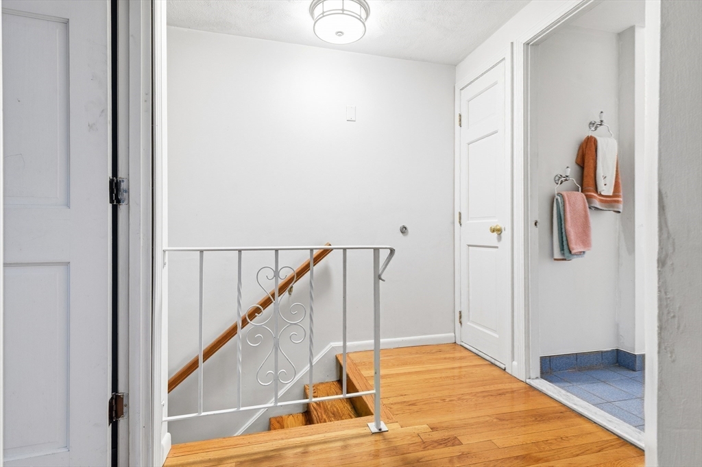 19 Clark Street Randolph, MA 02368 - Photo 24 of 30 a view of a hallway with wooden floor and staircase