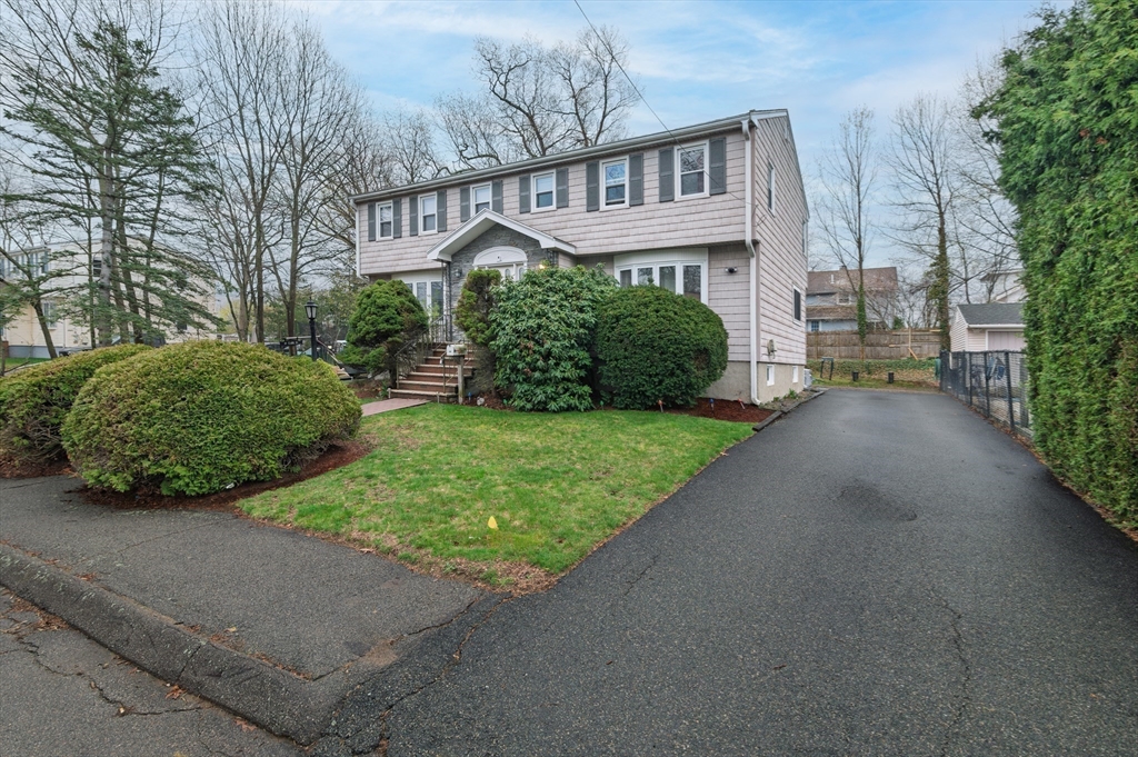 19 Clark Street Randolph, MA 02368 - Photo 27 of 30 a view of a house with a yard and potted plants