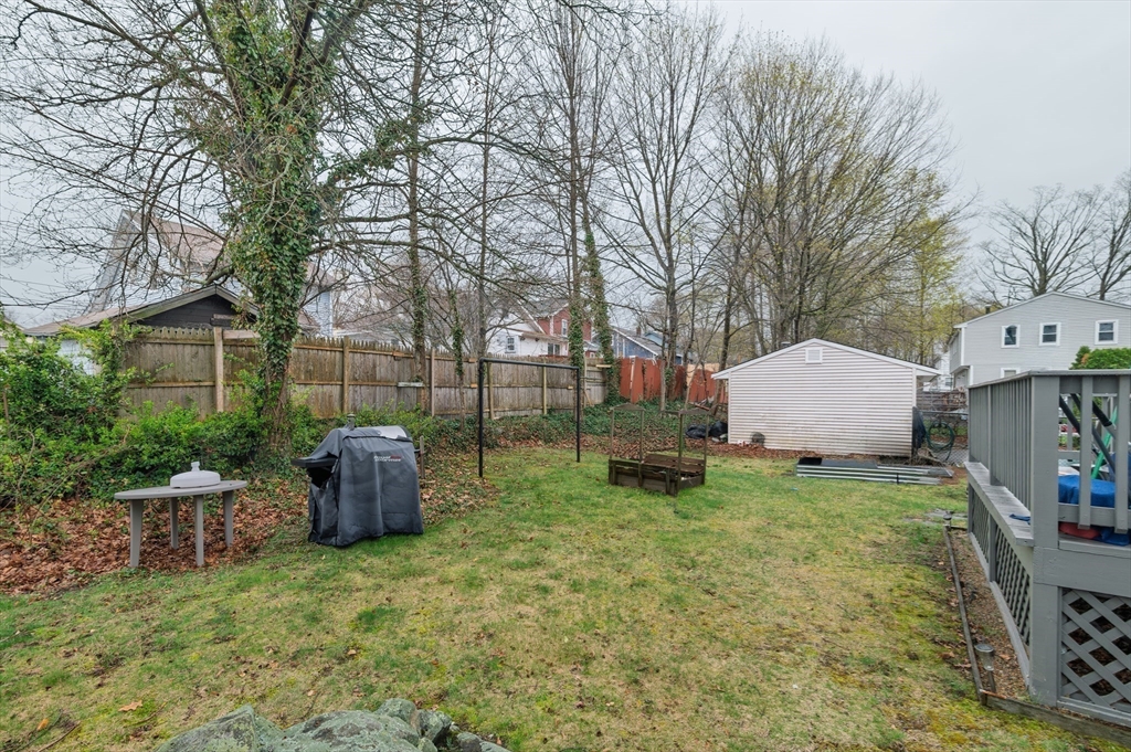 19 Clark Street Randolph, MA 02368 - Photo 5 of 30 a backyard of a house with oven and outdoor seating