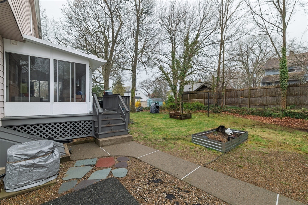 19 Clark Street Randolph, MA 02368 - Photo 6 of 30 a view of a wooden deck with chairs and a yard