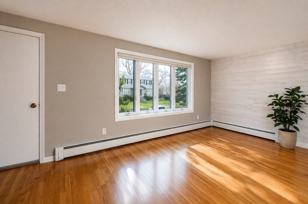 19 Clark Street Randolph, MA 02368 - Photo 9 of 30 a view of an empty room with glass door and wooden floor