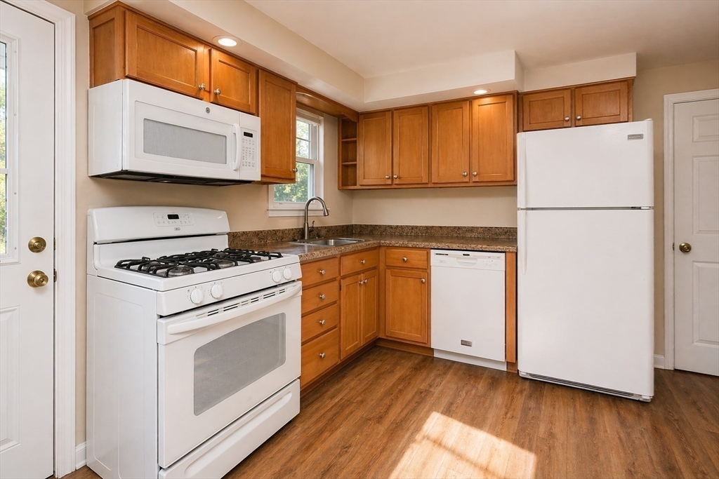 19 Clark Street Randolph, MA 02368 - Photo 10 of 30 a kitchen with a white cabinets and white appliances