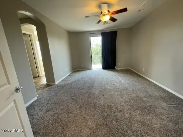 an empty room with windows and cabinet