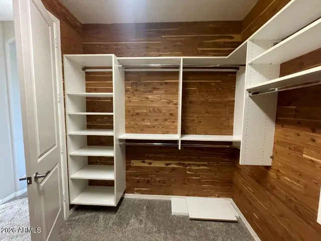 a view of walk in closet with empty racks
