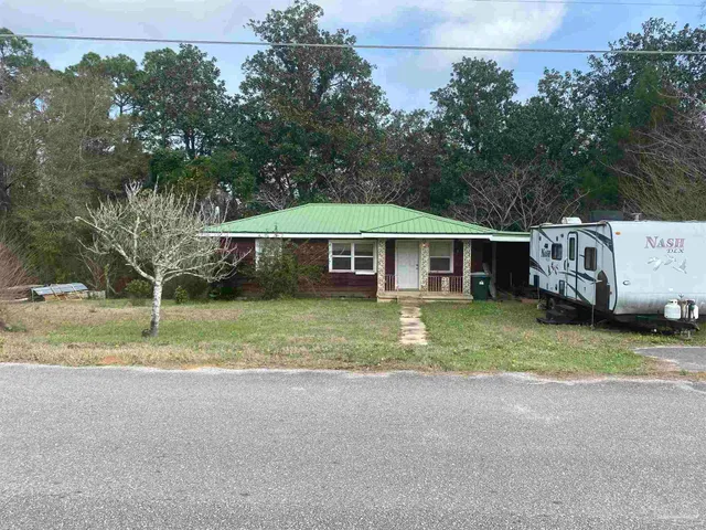 a view of house with outdoor space and swimming pool