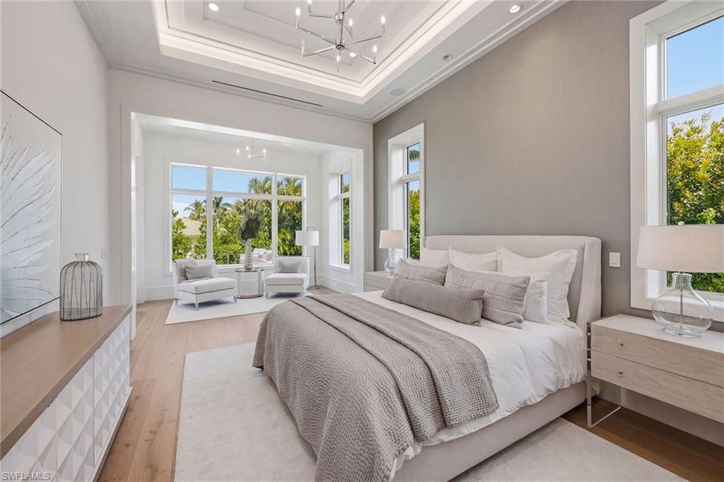 529 Neapolitan Way Naples, FL 34103 - Photo 13 of 26 a bedroom with bed and a large window