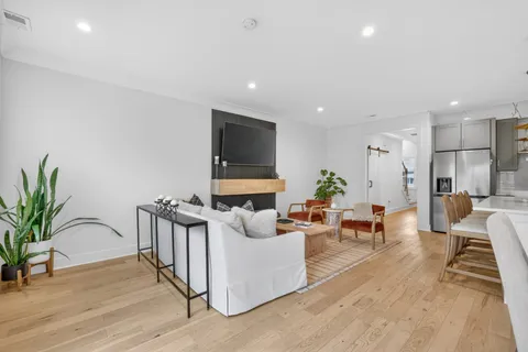 a view of living room with furniture and wooden floor