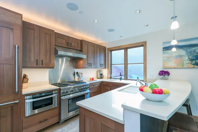 a kitchen that has a stove and a table