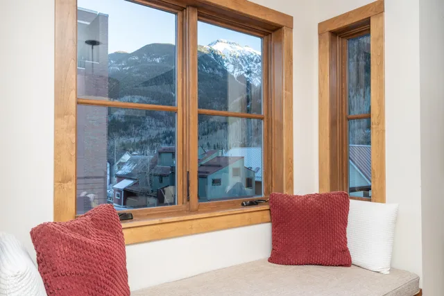 a living room with a large window and a couch