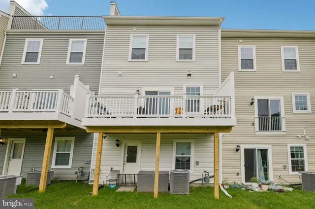 a view of a house with wooden fence
