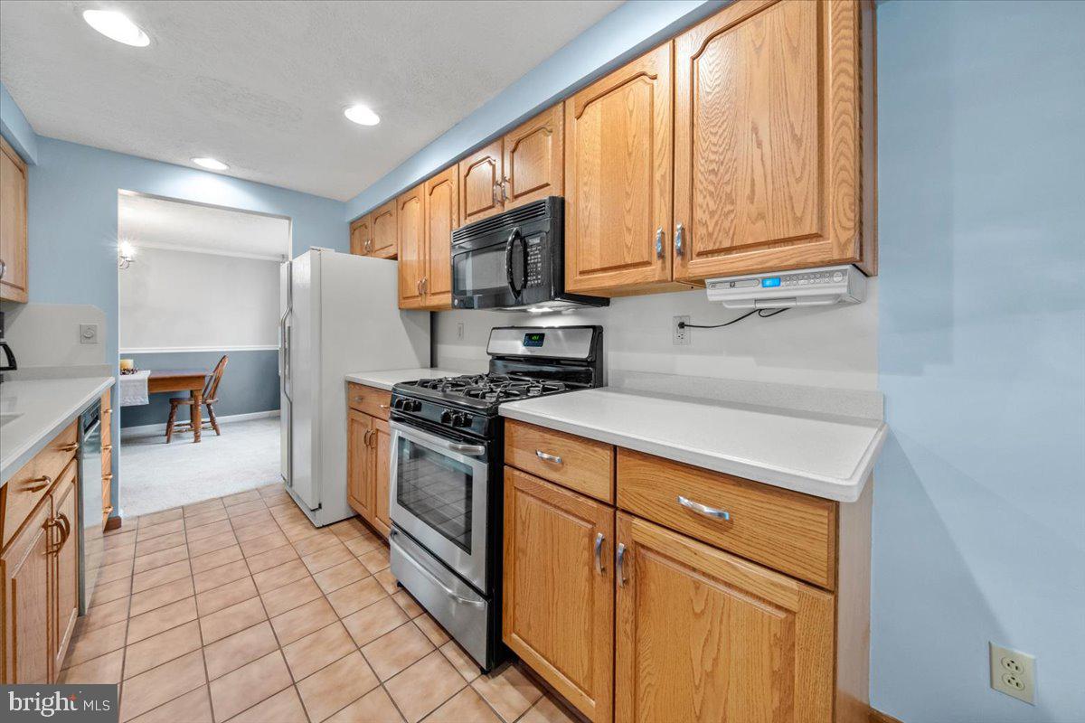 248 Winding Way Marlton, NJ 08053 - Photo 11 of 41 a kitchen with stainless steel appliances granite countertop a stove a sink and a refrigerator
