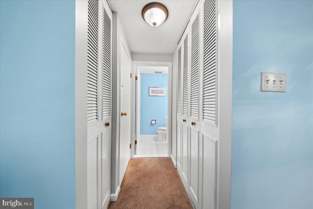 248 Winding Way Marlton, NJ 08053 - Photo 21 of 41 a view of a hallway with wooden floor and a bathroom