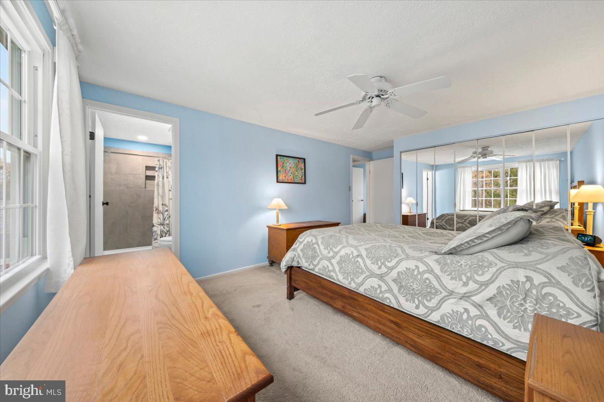 248 Winding Way Marlton, NJ 08053 - Photo 28 of 41 a spacious bedroom with a large bed and a chandelier