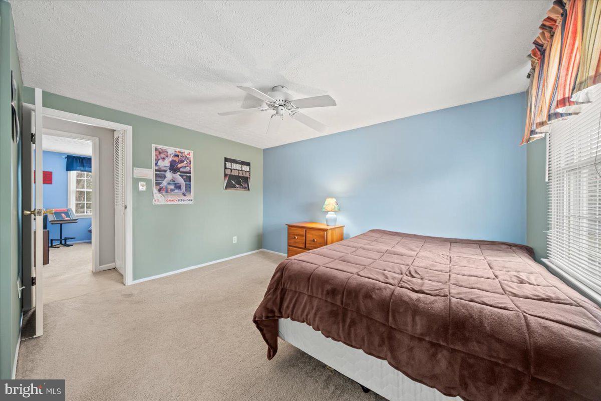 248 Winding Way Marlton, NJ 08053 - Photo 32 of 41 a bedroom with a large bed and a chandelier