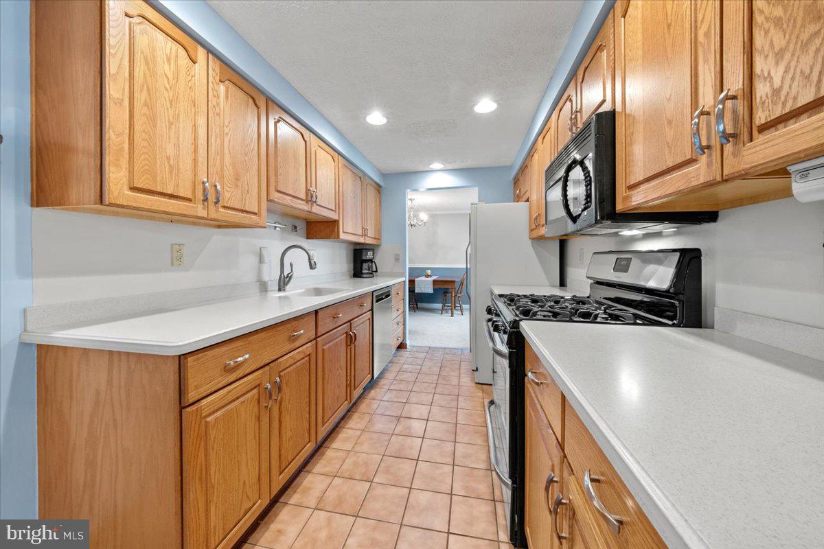248 Winding Way Marlton, NJ 08053 - Photo 10 of 41 a kitchen with stainless steel appliances granite countertop a sink a stove and a refrigerator