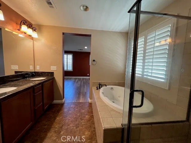 a large bathroom with a tub and a shower