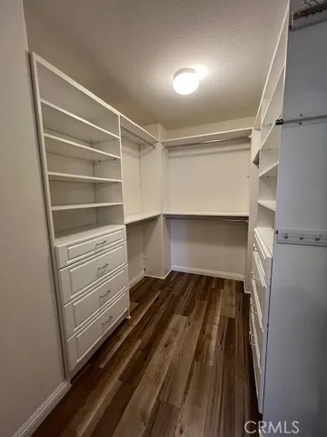 a view of walk in closet with empty racks