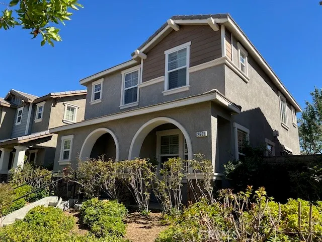 a front view of a house with a garden