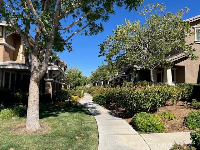 a view of a house with a tree in front of it