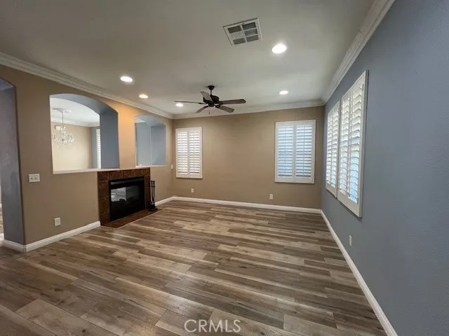 a view of an empty room with a window and fireplace