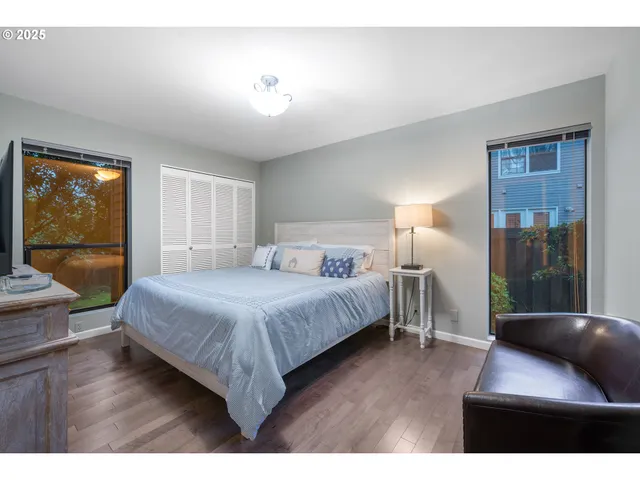 a bedroom with a bed and a large window