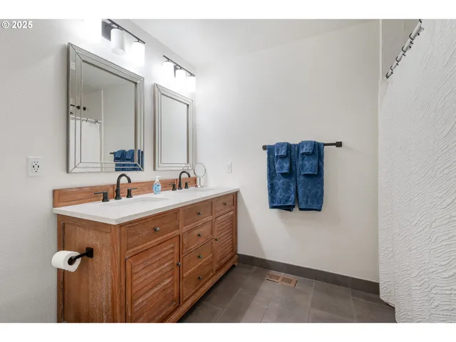 a bathroom with a sink vanity and mirror