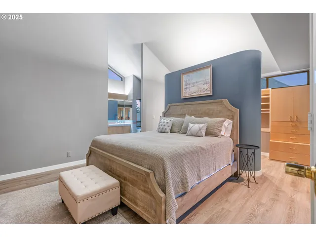 a bedroom with a bed and a large mirror