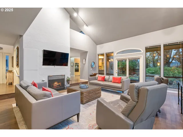 a living room with fireplace furniture and a flat screen tv