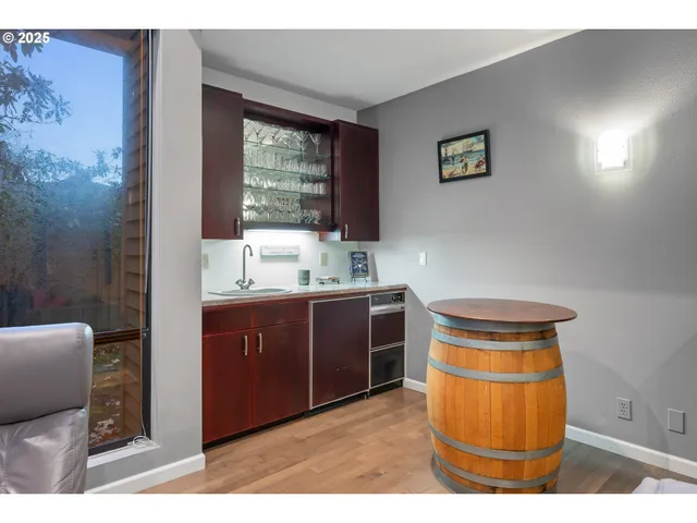 a kitchen with a sink cabinets and wooden floor