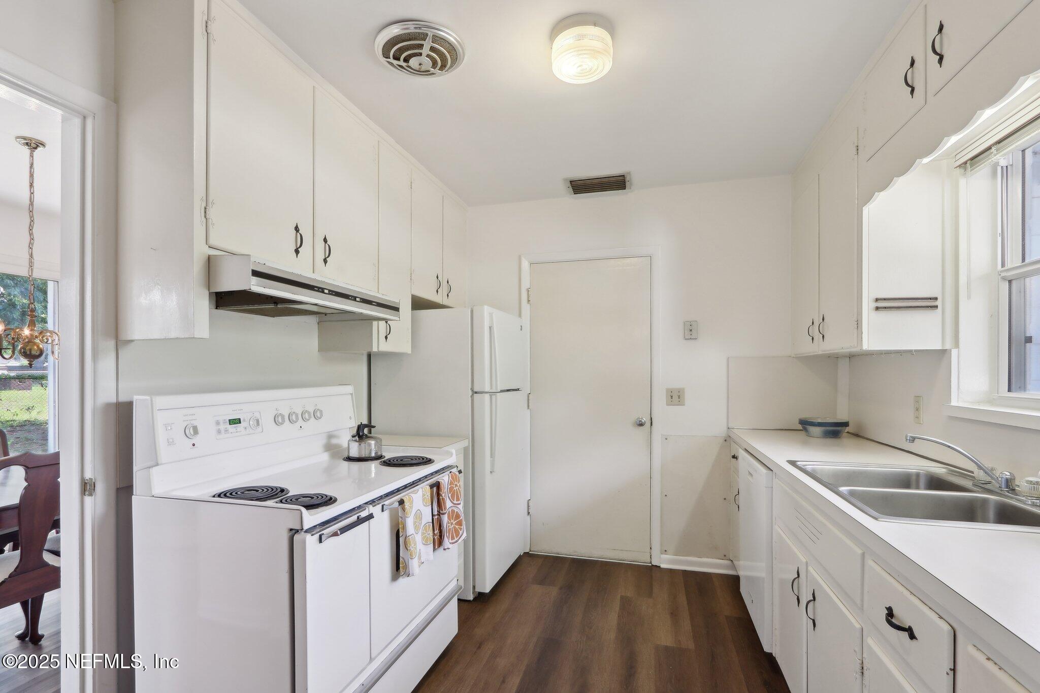 3831 Rogero Road Jacksonville, FL 32277 - Photo 12 of 33 a kitchen with a sink a stove and refrigerator