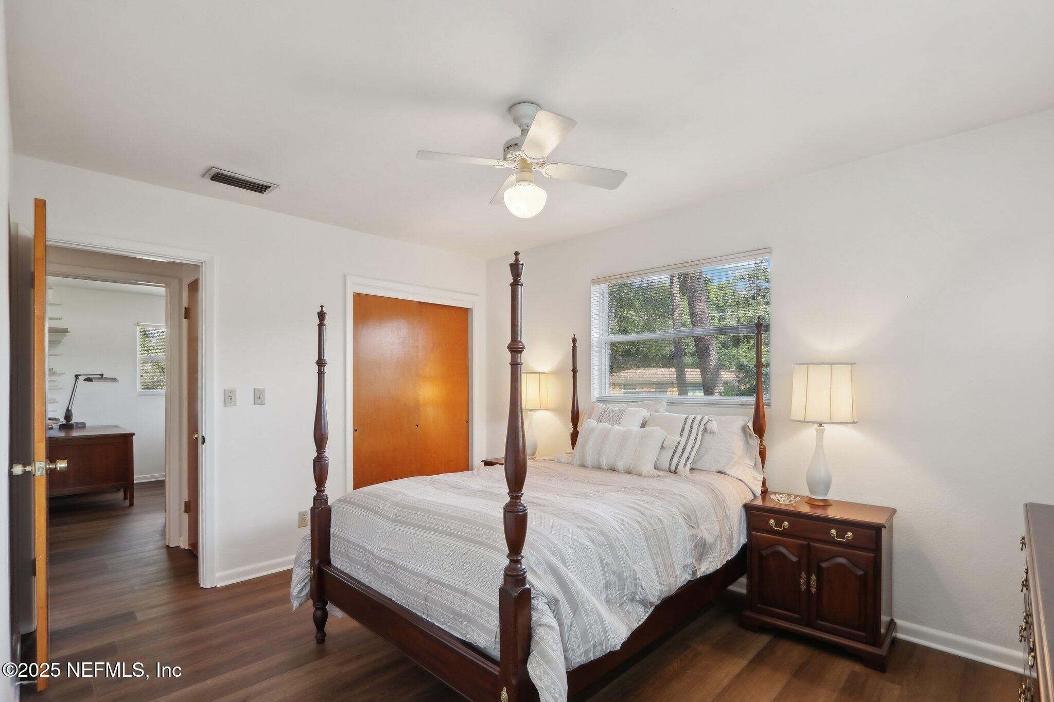 3831 Rogero Road Jacksonville, FL 32277 - Photo 15 of 33 a bedroom with a bed and wooden floor