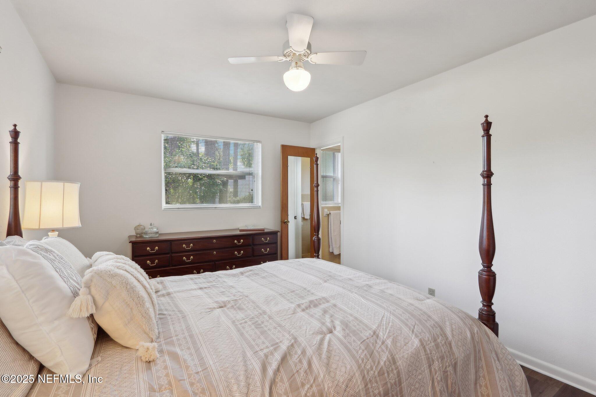 3831 Rogero Road Jacksonville, FL 32277 - Photo 16 of 33 a bedroom with a large bed and a window