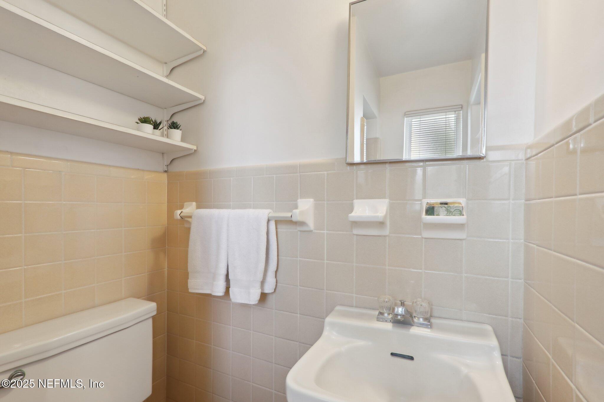 3831 Rogero Road Jacksonville, FL 32277 - Photo 18 of 33 a bathroom with a sink a toilet and shower