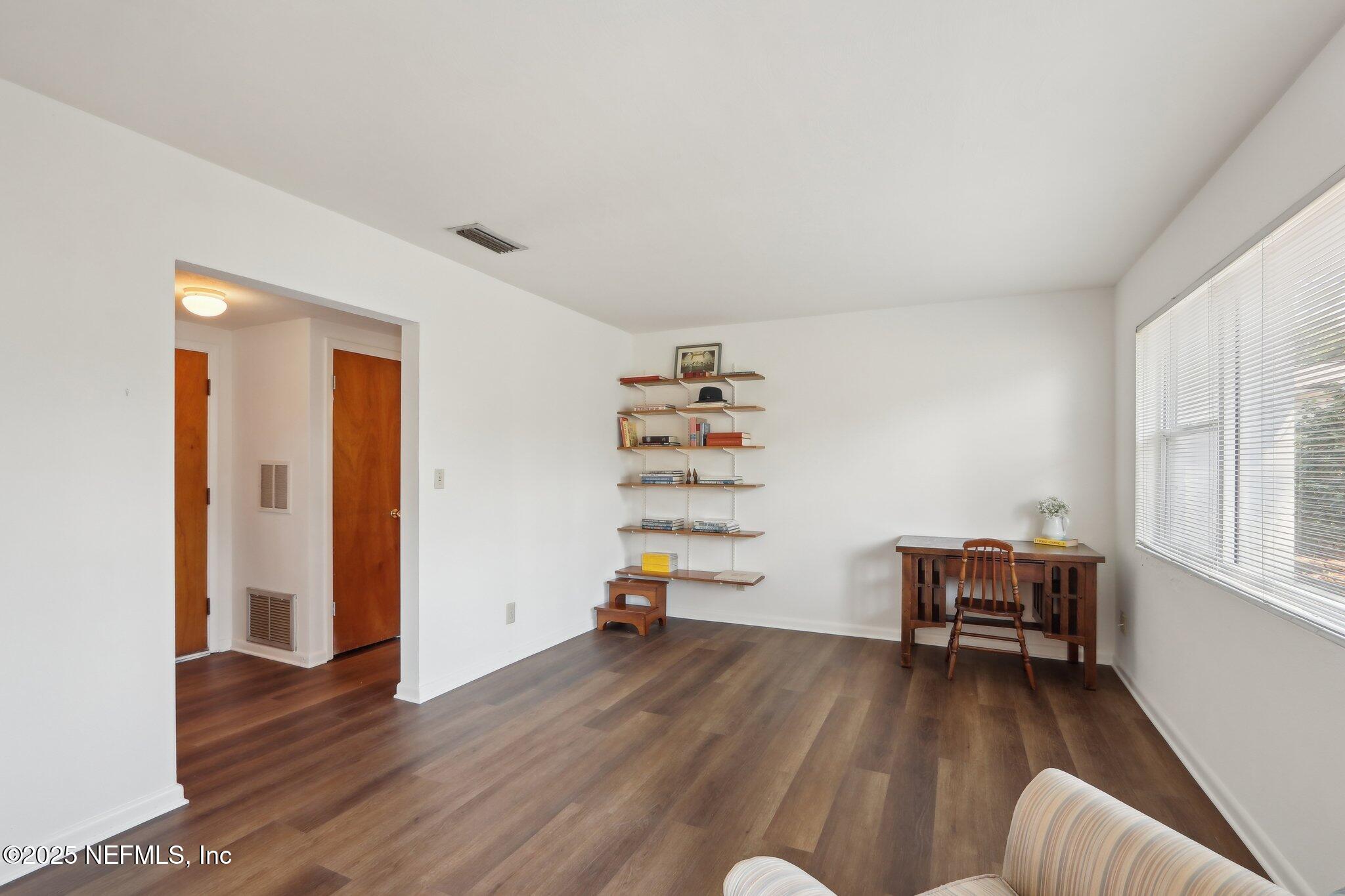 3831 Rogero Road Jacksonville, FL 32277 - Photo 3 of 33 a living room with furniture and a wooden floor