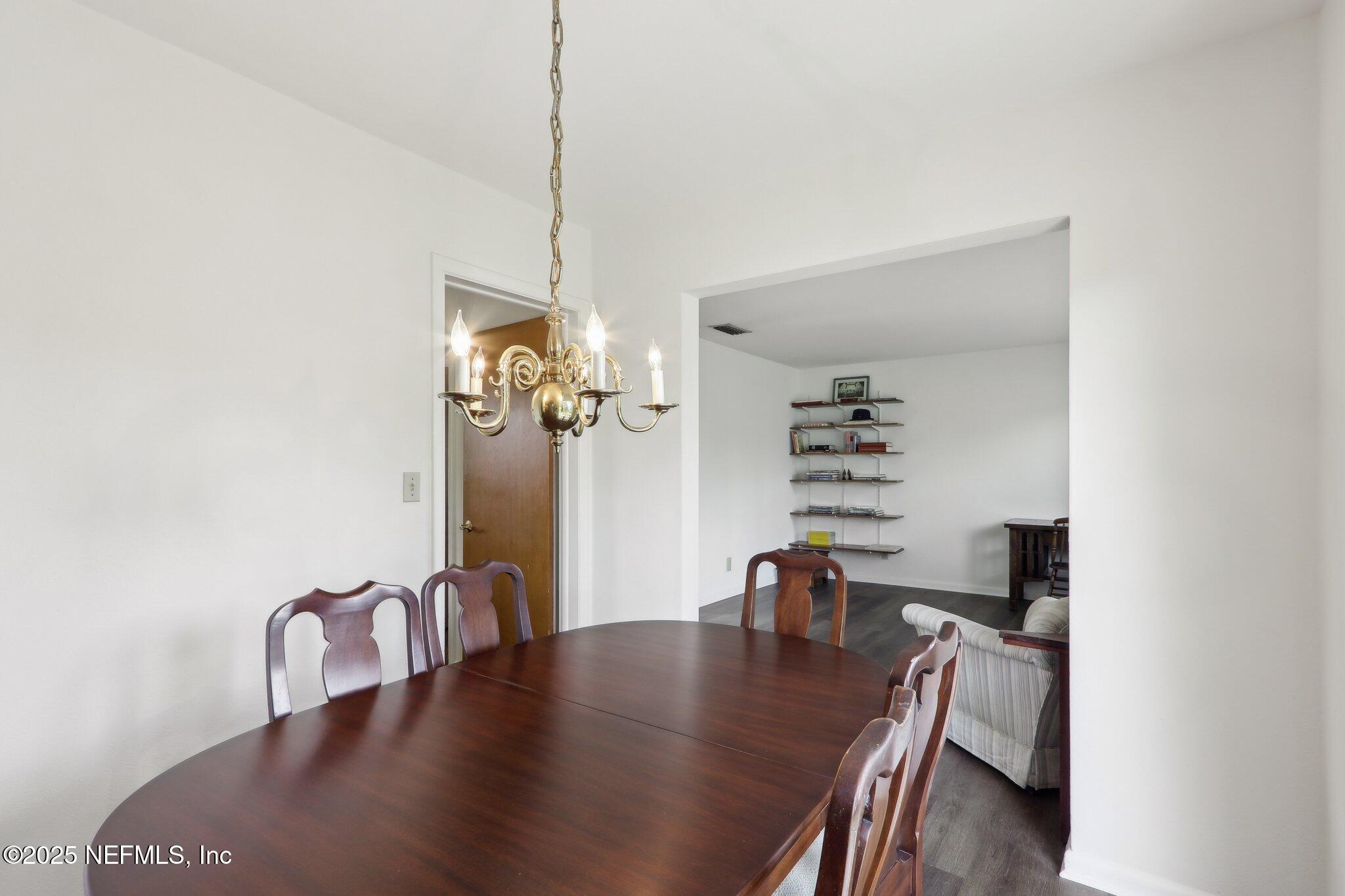 3831 Rogero Road Jacksonville, FL 32277 - Photo 7 of 33 a dining room with furniture and wooden floor