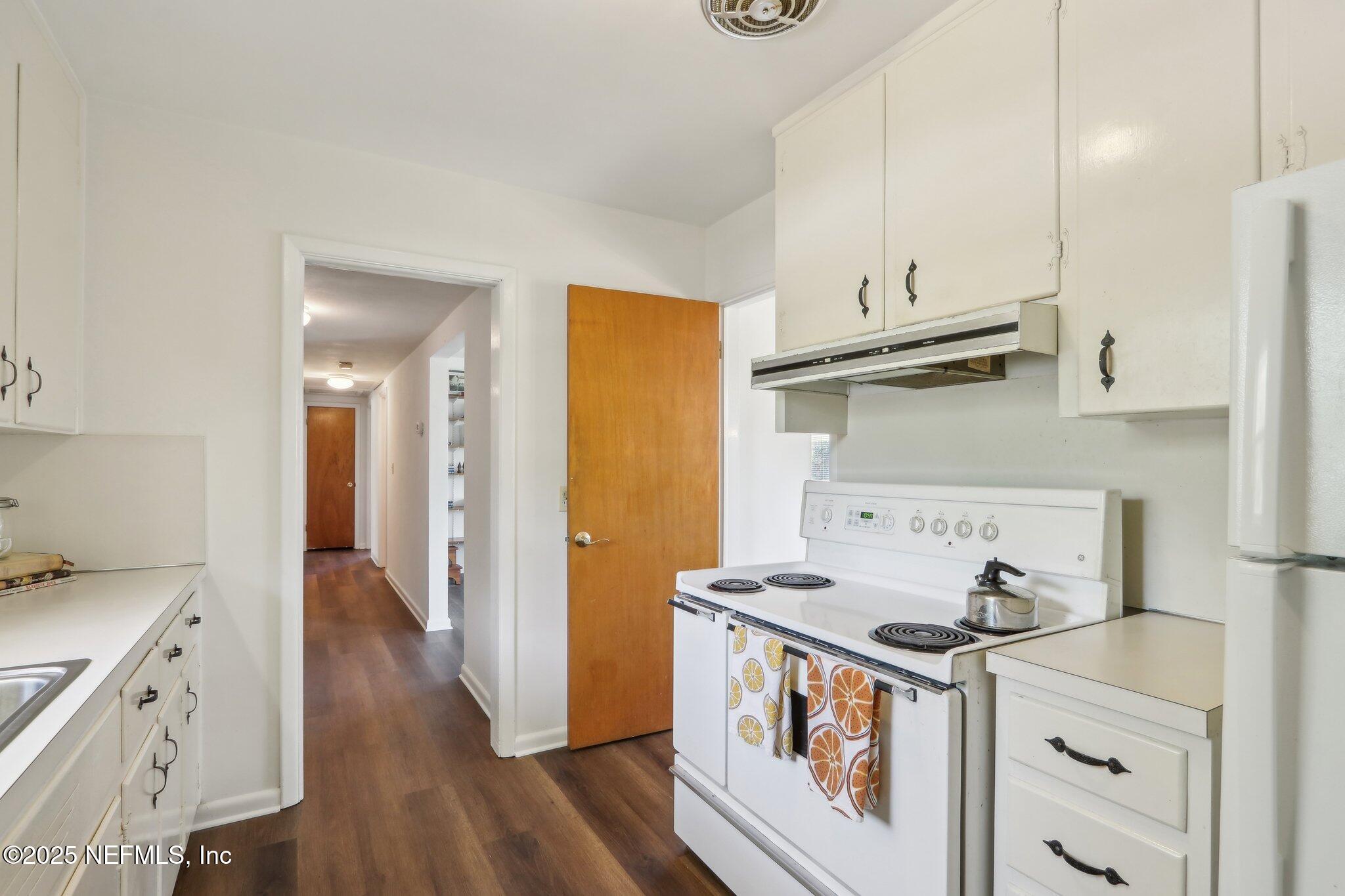 3831 Rogero Road Jacksonville, FL 32277 - Photo 10 of 33 a kitchen with stainless steel appliances a stove a sink and a refrigerator